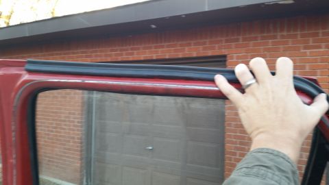 1981 Ford Bronco - Installing new weatherstripping on a vehicle door frame.