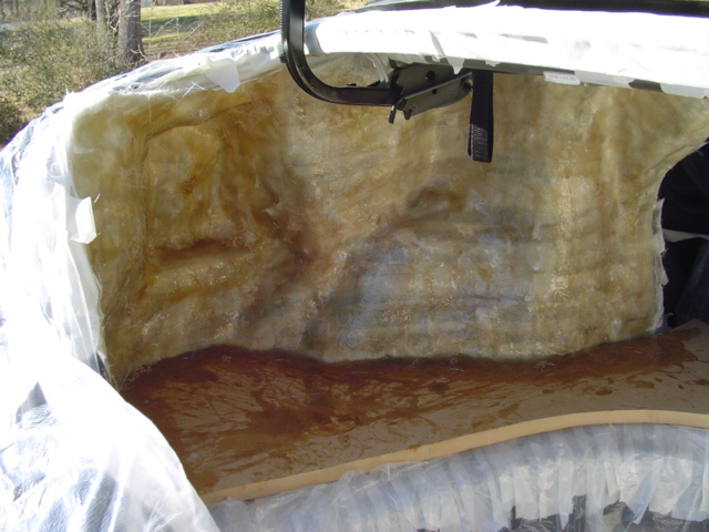 Fiberglass insulation lining the inside of a car trunk