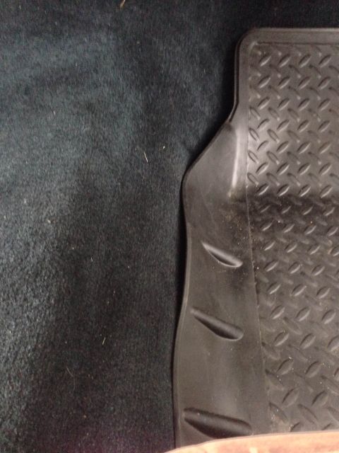 1979 Ford Bronco - Rubber floor mat with diamond tread pattern shown on dark carpet.