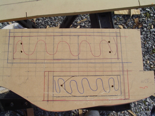 Cardboard mock-up template with red and blue layout lines for a custom trunk mounting panel
