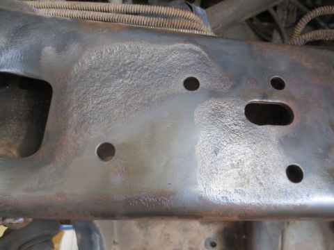 1996 Ford Bronco - Close-up of a vehicle frame section, showing rust and mounting holes.