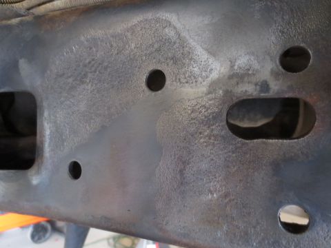 1996 Ford Bronco - A close-up view of the vehicle's frame, showing its structural components and some surface wear.
