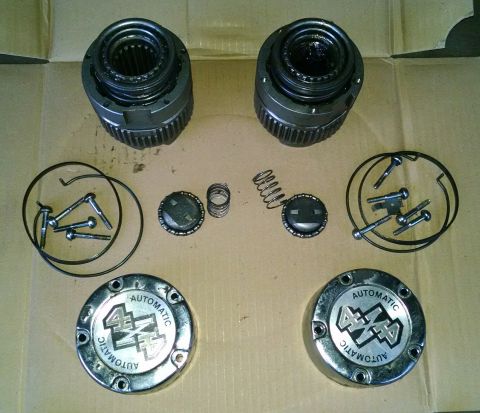 1994 Ford Bronco - Automatic 4x4 hubcaps and their internal components are displayed, suggesting they are for a vehicle with four-wheel drive capability.