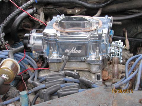 1978 Ford Bronco - A shiny Demon carburetor is the focus, surrounded by engine components and wiring.