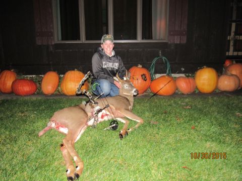 1978 Ford Bronco - Hunter poses with a deer and bow in front of pumpkins on a lawn.