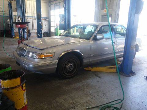 2000 Mercury Grand Marquis - Silver 2000 Mercury Grand Marquis undergoing service on a car lift.
