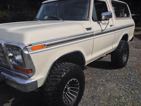 1979 Ford Bronco - This lifted Ford Bronco sits on a gravel lot, its off-road tires and classic body style.