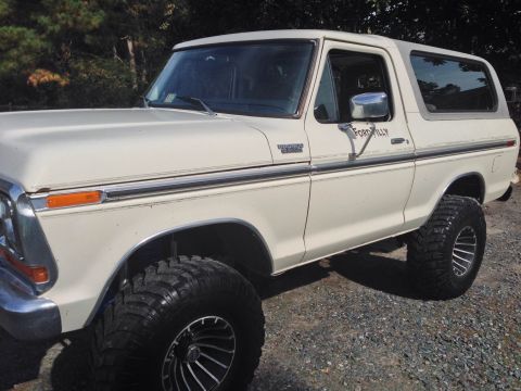 1979 Ford Bronco - This white Ford Bronco features a lifted suspension and large off-road tires.