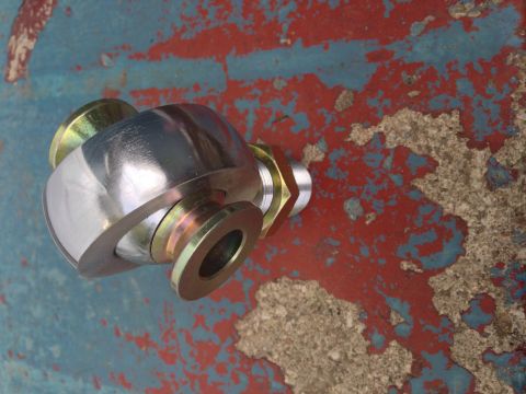 1979 Ford Bronco - A close-up shot of a metal rod end joint, possibly for a vehicle's suspension or steering system.