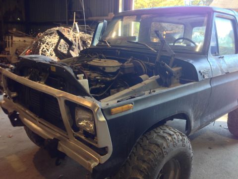 1979 Ford Bronco - This Ford Bronco is in a garage with its hood up, revealing the engine compartment.