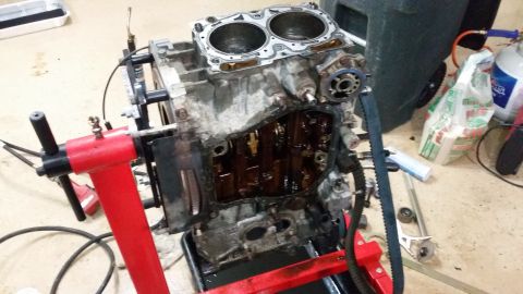 2007 Subaru Impreza - Disassembled engine block on a stand, showing internal components and oil residue.