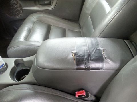 2001 Ford Explorer - The center console armrest of this vehicle has been repaired with duct tape.