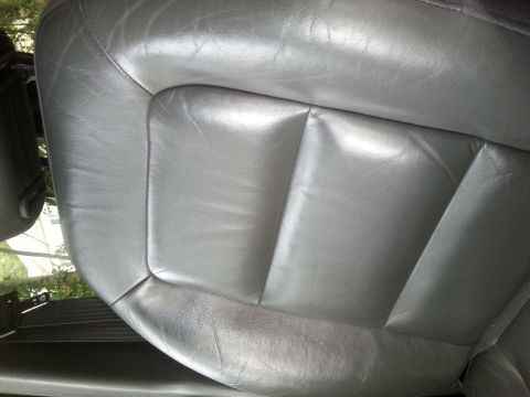 2001 Ford Explorer - Close-up of a gray leather car seat interior.