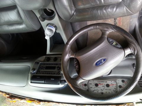 2001 Ford Explorer - The interior of a 2001 Ford Explorer, the steering wheel, dashboard, and center console.