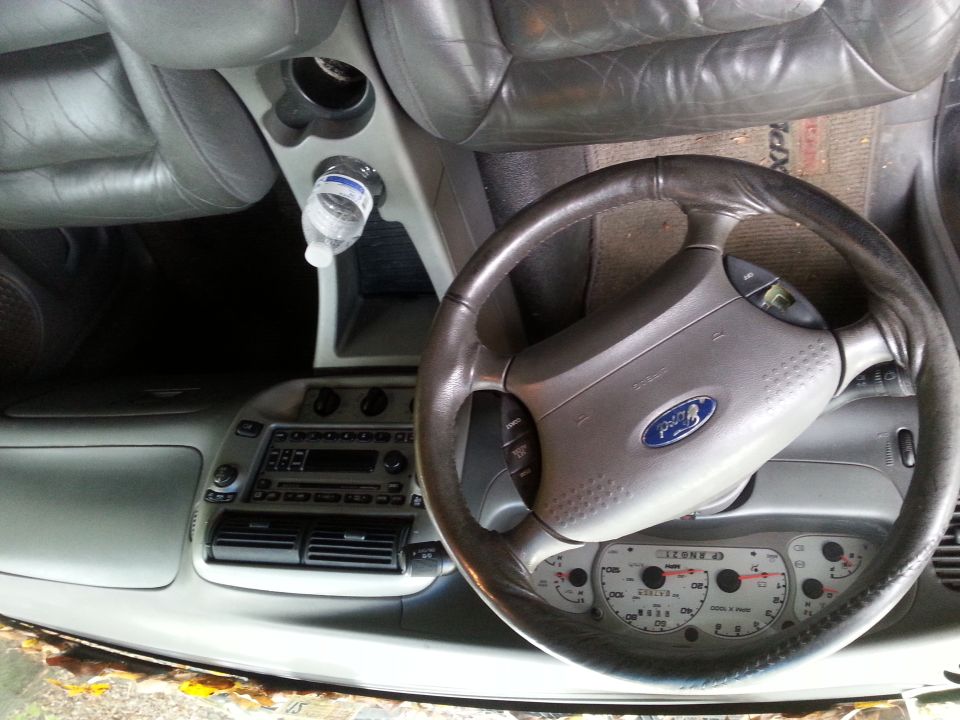 Interior of a 2001 Ford Explorer showing the steering wheel and dashboard