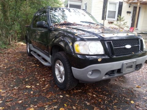 2001 Ford Explorer - This 2001 Ford Explorer Sport Trac is seen from a 3q front angle, parked on a leaf-covered driveway.