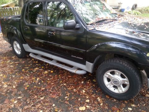 2001 Ford Explorer - Side view of a black 2001 Ford Explorer Sport Trac pickup truck.
