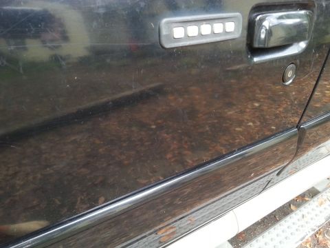 2001 Ford Explorer - Close-up of a black SUV door, showing the keypad entry system and door handle.