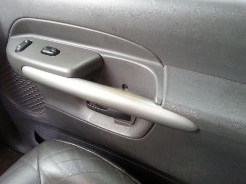 2001 Ford Explorer - Close-up of the driver's side interior door panel, showing the window controls and door handle.