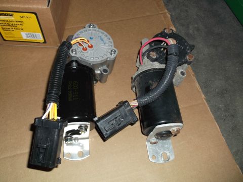 2005 Ford F-150 - Pair of electric transfer-case shift motors with wiring connectors atop a Dorman 600-911 carton.