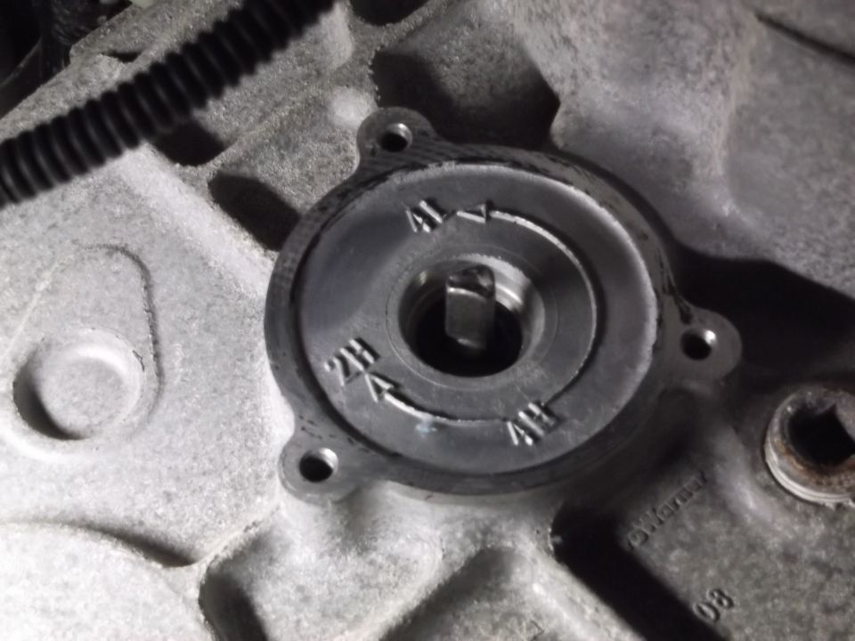 Close-up of a transfer case shift mechanism with 2H, 4H, 4L markings