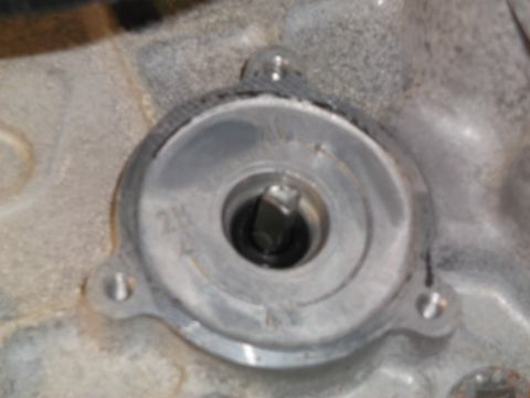 2005 Ford F-150 - A close-up view of a metal component with a hex-shaped socket in the center. The component is attached to a larger, textured metal surface,…