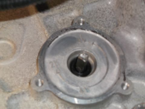 2005 Ford F-150 - A close-up view of a metal component with a square-shaped fitting in the center. There is some text visible on the surface, including "2N"…