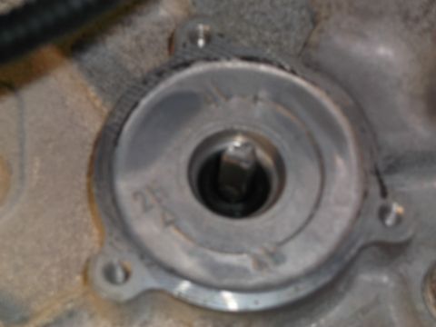 2005 Ford F-150 - A close-up, slightly blurry view of a metal component with a central opening. Visible markings include "2H" and a "4" with a line through i…