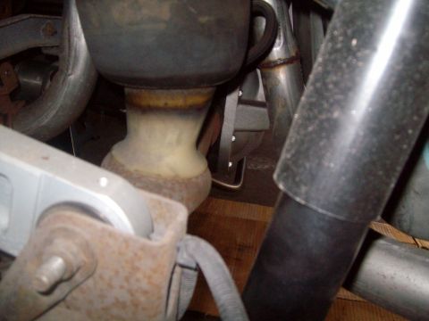 2004 Ford Crown Victoria - This close-up photo shows the underside of a vehicle, focusing on the exhaust system and suspension components. Visible parts include a bla…