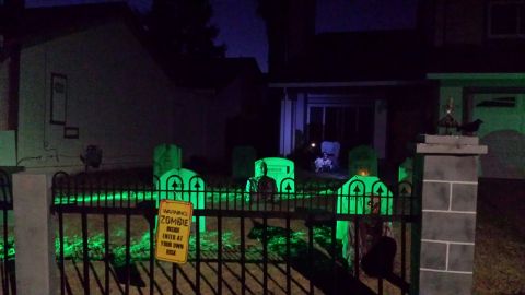 1989 Ford Bronco - A Halloween display features a graveyard with glowing green tombstones and a "Warning Zombie Inside" sign.