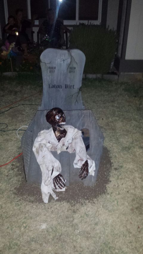 1989 Ford Bronco - A Halloween decoration depicts a zombie emerging from a tombstone. The tombstone reads "Eaton Dirt" and has dates "BORN 1837" and "DIED 189…