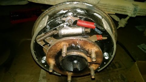 1994 Ford Bronco - This is a close-up view of the internal components of a drum brake system, likely from a 1994 Ford Bronco. The image shows brake shoes, spr…