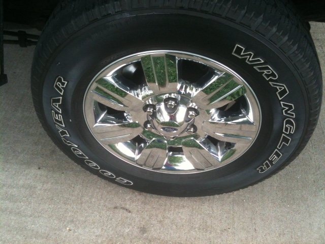 Close-up of a Goodyear Wrangler tire on a chrome wheel.