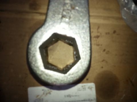 2001 Ford Explorer - A close-up shot shows the hexagonal opening of a wrench, likely a socket wrench head, resting on a wooden surface. The wrench appears to be…