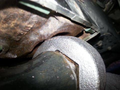 2001 Ford Explorer - A close-up view shows a large, silver wrench being used on a rusty, hexagonal bolt head. The surrounding area appears to be part of a vehic…