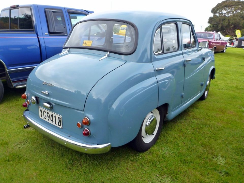Light blue vintage sedan, rear passenger side view, license plate YG9410