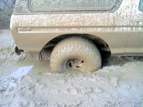 1978 Ford Bronco - This 1978 Ford Bronco is deeply stuck in thick mud, with its rear wheel submerged.