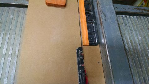 1992 Ford Bronco - A close-up view of a table saw fence and its guide rail.