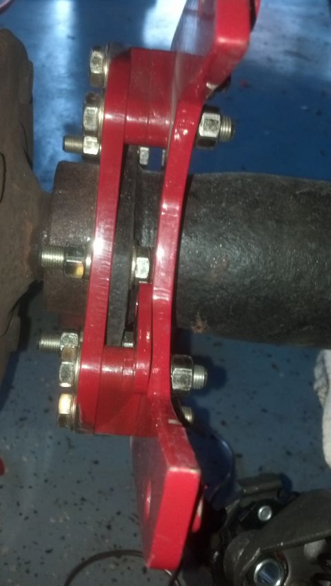 1996 Ford Bronco - The caliper now just barely clears the mounting bolt. The mounting boss is now visible on the inboard side.