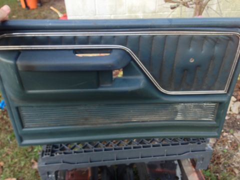 1979 Ford Bronco - A detached car door panel, likely from an older model, is shown with its interior trim details.