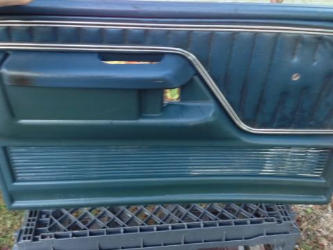 1979 Ford Bronco - Interior door panel from a 1979 Ford Bronco, blue upholstery and chrome accents.