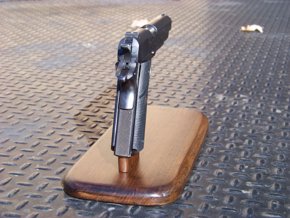 Handgun on a wooden stand.