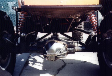 1990 Ford Bronco - Close-up view of the rear axle and suspension components on a custom off-road vehicle.
