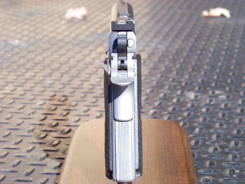 1995 Mercury Grand Marquis - A close-up, top-down view of the rear sights and slide of a semi-automatic pistol. The pistol has a silver slide and black grip panels, res…