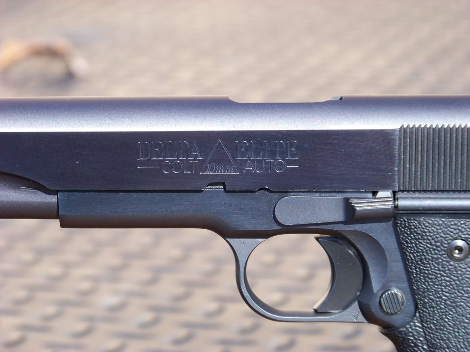 Close-up of a handgun slide with engraving.