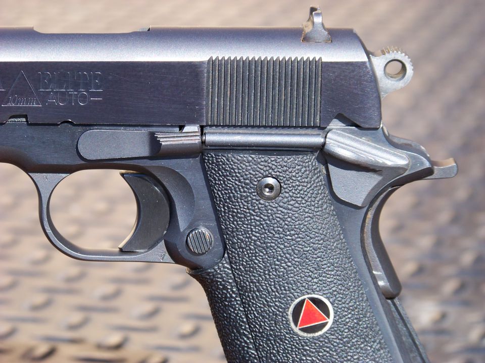 Close-up of a black semi-automatic handgun with textured grips.
