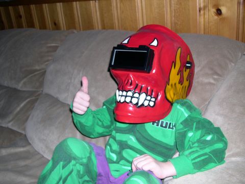 1986 Ford Bronco - Child wearing a Hulk costume and a skull-themed welding mask gives a thumbs up.