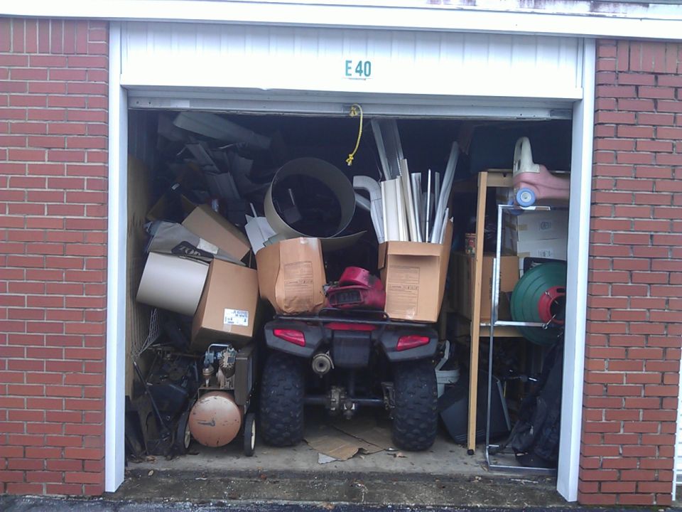 2006 Honda Rancher ATV in a storage unit, surrounded by boxes.