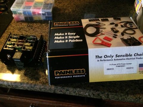 1979 Ford Bronco - A Painless Performance Products 11-fuse ATO fuse center is shown next to a box containing various automotive electrical components. A clear…