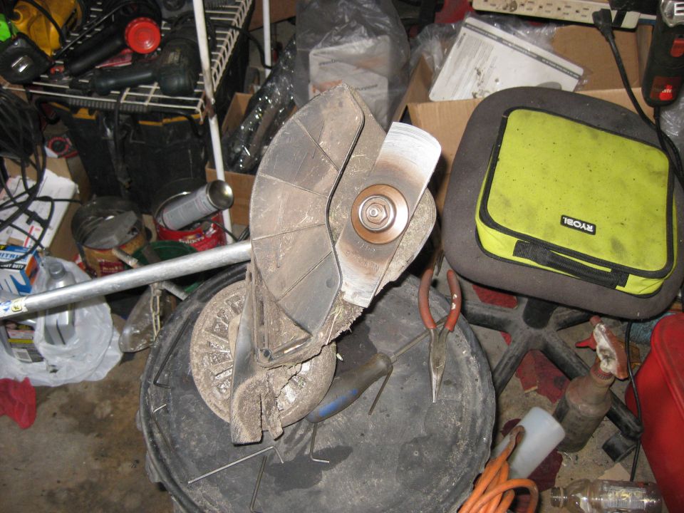 Cluttered garage scene with tools and equipment.